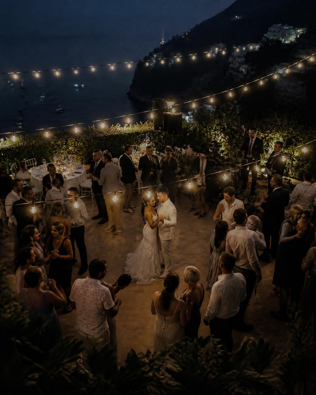 Bride and groom dancing with guests at an evening wedding reception in Cyprus